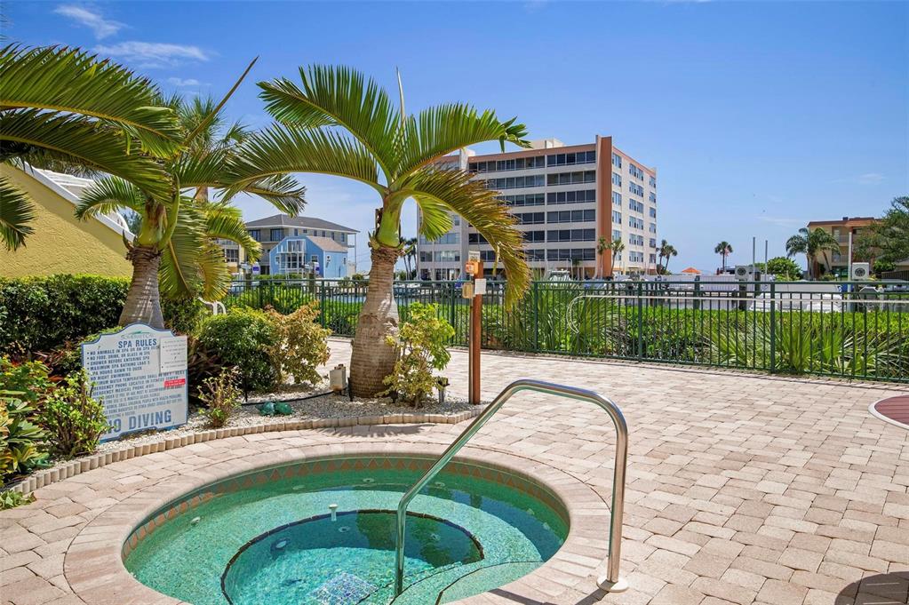 9122 Midnight Pass Road, Unit 34 Sarasota, FL 34242 - Photo 48 of 61 a swimming pool with outdoor seating and yard