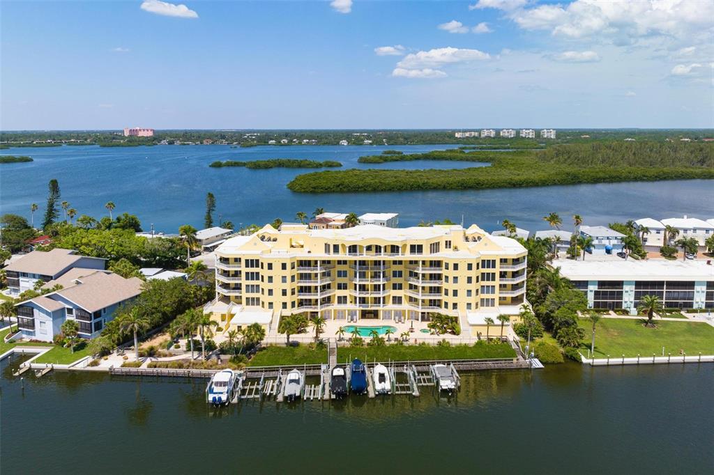 9122 Midnight Pass Road, Unit 34 Sarasota, FL 34242 - Photo 58 of 61 a view of a lake with building in the background