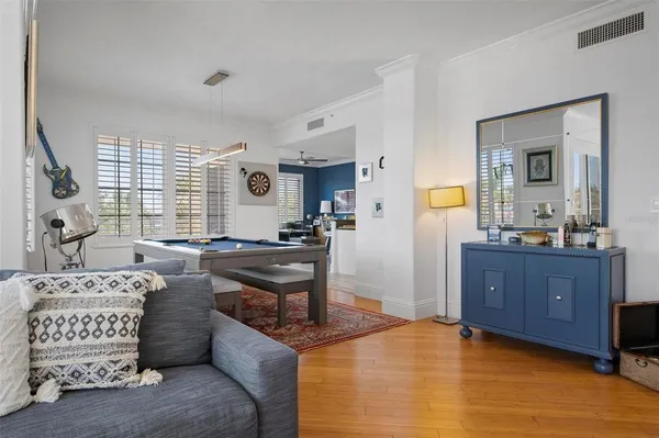 a living room with a bed furniture and a window