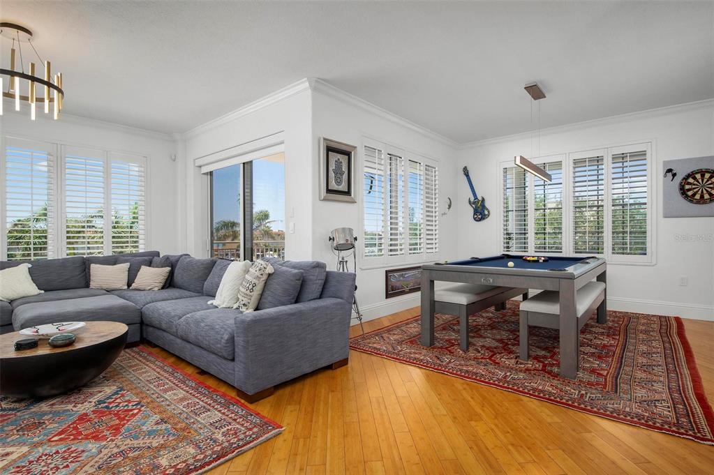 9122 Midnight Pass Road, Unit 34 Sarasota, FL 34242 - Photo 9 of 61 a living room with furniture a wooden floor and next to a window
