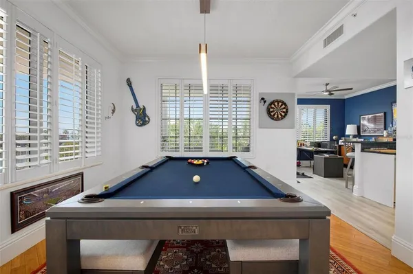 a view of a workspace with furniture and a large window