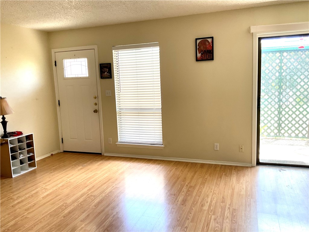 6718 Silvermine Drive, Unit 704 Austin, TX 78736 - Photo 8 of 20 a view of an empty room with wooden floor and a window