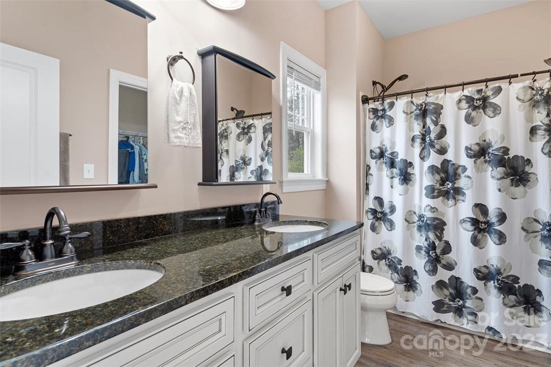 330 Manchester Road Mount Gilead, NC 27306 - Photo 17 of 30 a bathroom with a granite countertop sink and a mirror