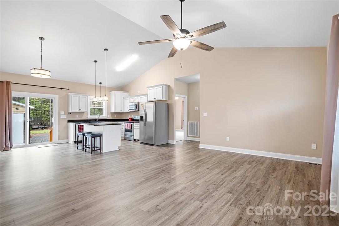 330 Manchester Road Mount Gilead, NC 27306 - Photo 6 of 30 an open kitchen with a table and chairs
