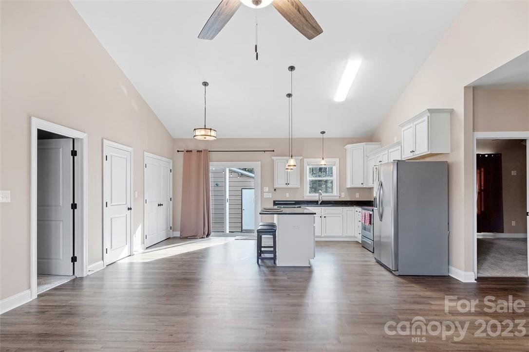330 Manchester Road Mount Gilead, NC 27306 - Photo 7 of 30 a kitchen with kitchen island white cabinets and stainless steel appliances