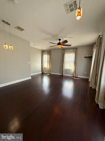 a view of a livingroom with wooden floor and a window