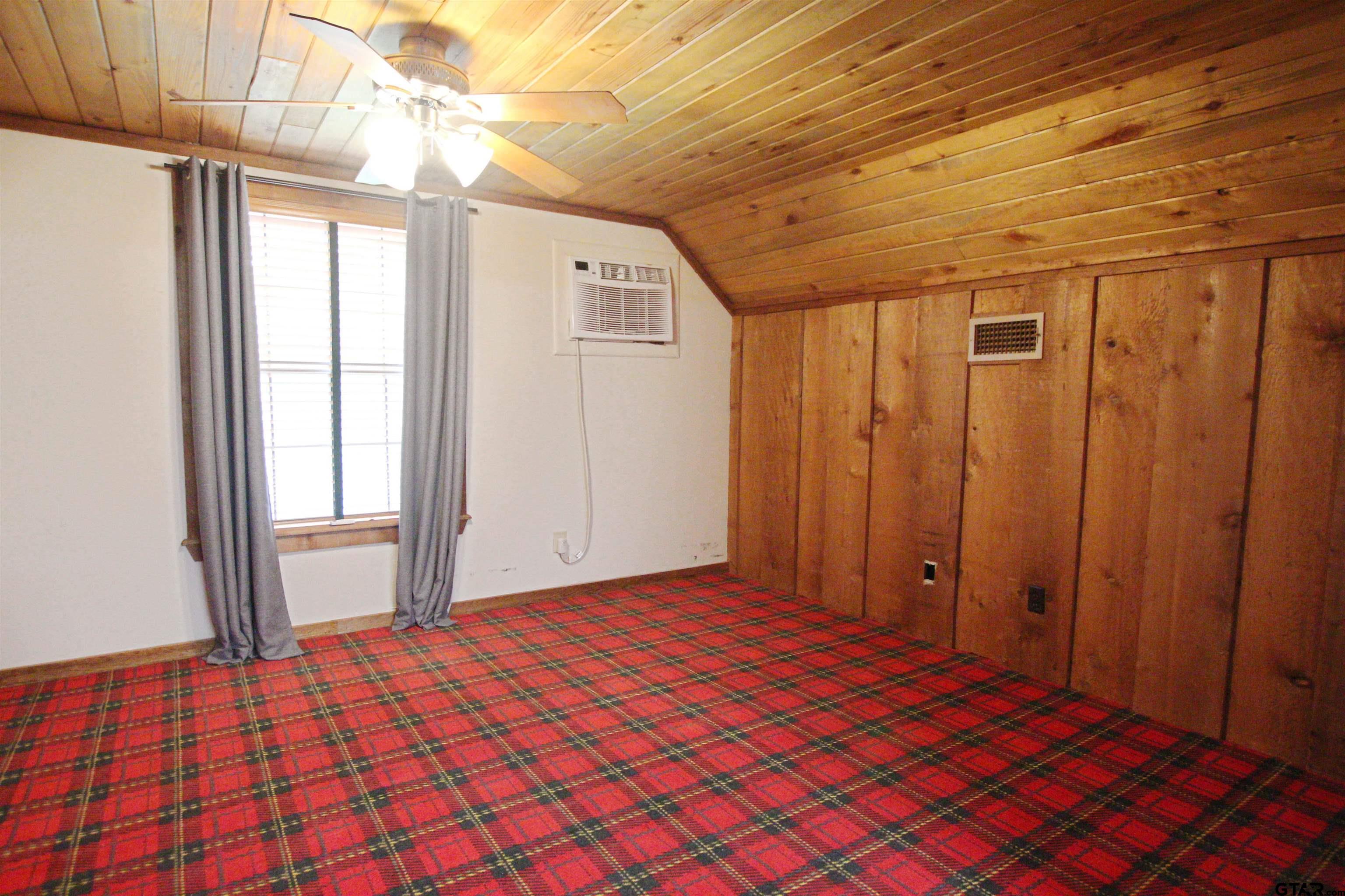 782 Rosie Wady Road Gladewater, TX 75647 - Photo 23 of 48 a bedroom with a bed and a window