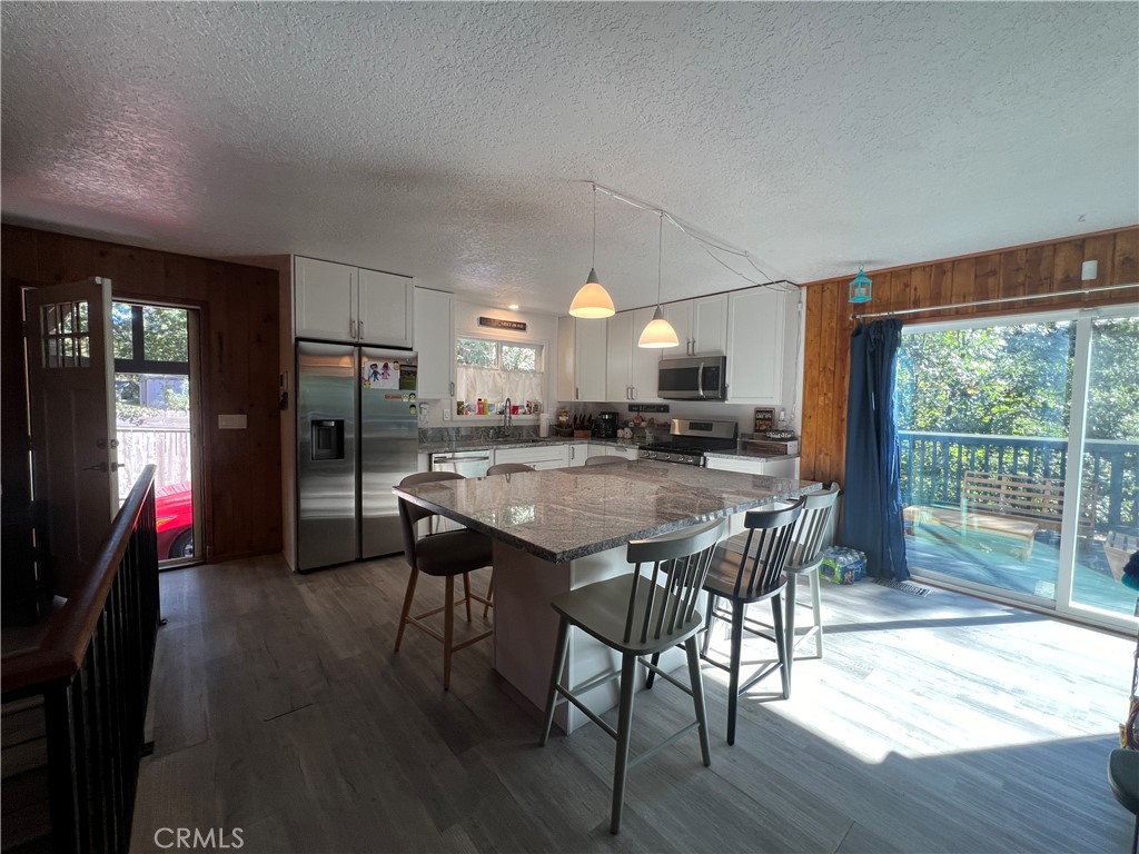 23857 Zuger Drive Crestline, CA 92325 - Photo 13 of 29 a view of a dining room with furniture window and wooden floor