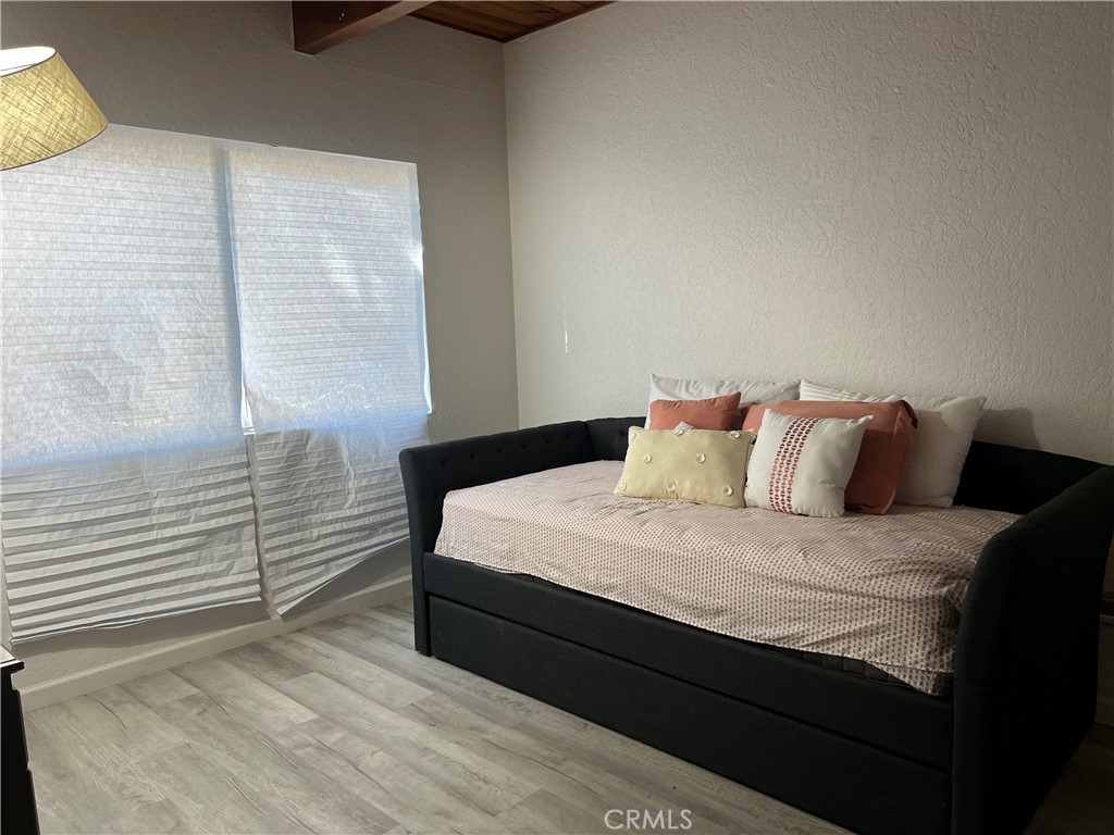 23857 Zuger Drive Crestline, CA 92325 - Photo 22 of 29 a bedroom with a bed and a night stand
