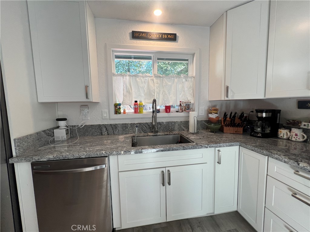 23857 Zuger Drive Crestline, CA 92325 - Photo 3 of 29 a kitchen with stainless steel appliances granite countertop a sink window and cabinets