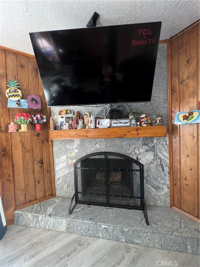 23857 Zuger Drive Crestline, CA 92325 - Photo 7 of 29 a living room with a fireplace furniture and a flat screen tv