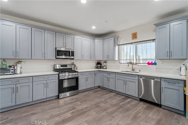a kitchen with sink cabinets and stainless steel appliances