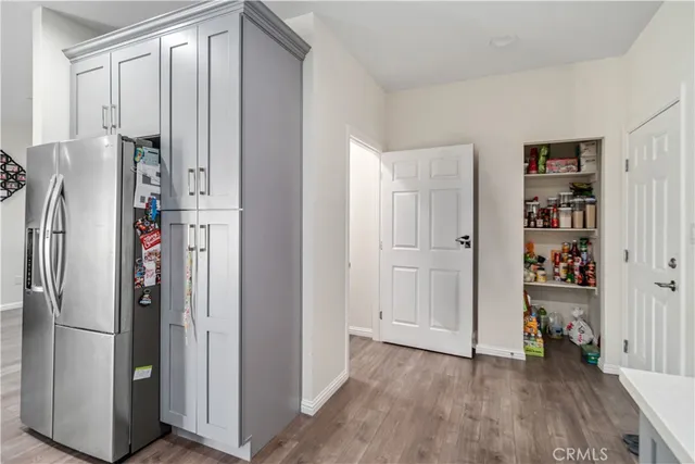 a view of walk in closet with hardwood floor and closet