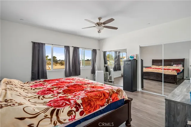 a bed room with a bed and a television