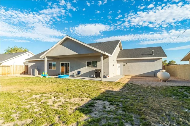 a front view of a house with swimming pool and porch