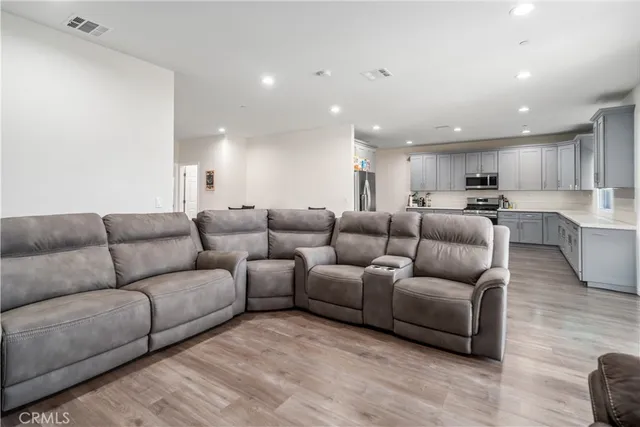 a living room with furniture and kitchen view