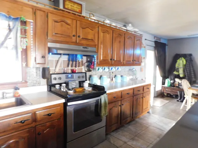 a kitchen with stainless steel appliances granite countertop a sink and cabinets