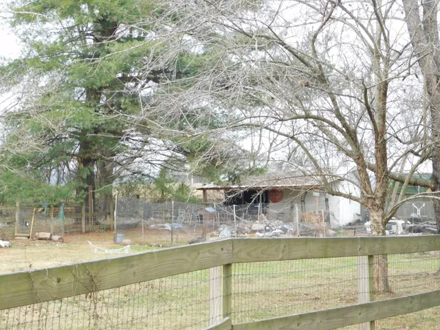 a backyard of a house with barbeque oven