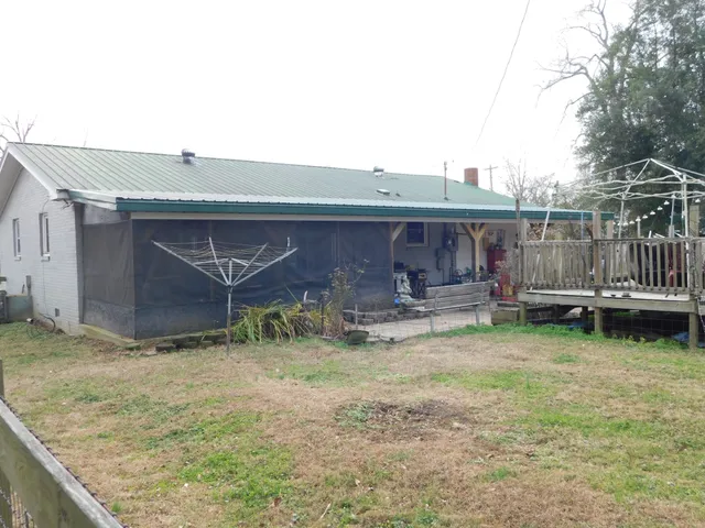 a view of a yard with wooden fence