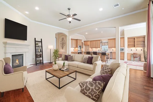 a living room with furniture fireplace and a flat screen tv