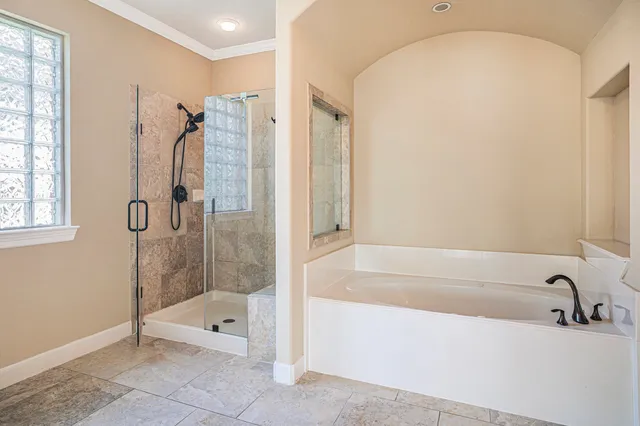 a bathroom with a bathtub and a shower