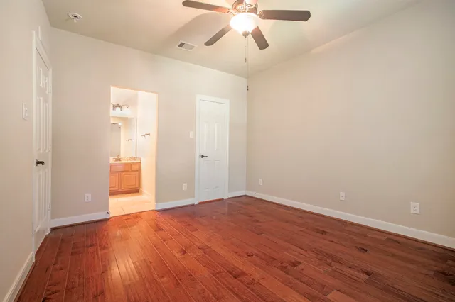 a view of an empty room and wooden floor