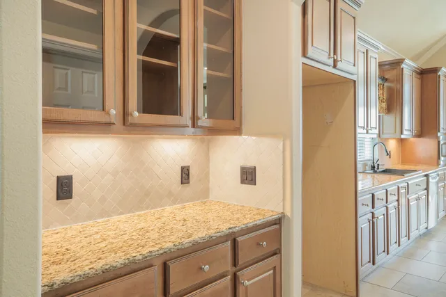 a bathroom with a granite countertop sink and a window