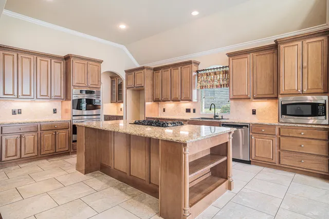 a kitchen with a stove top oven sink and cabinets