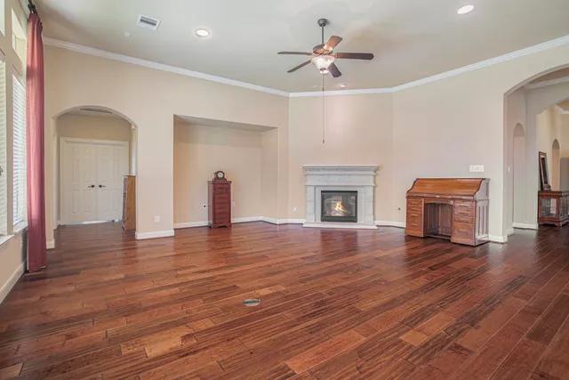 a view of empty room with wooden floor and fireplace
