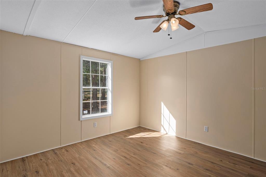 4939 West Foxhill Lane Homosassa, FL 34446 - Photo 15 of 37 a view of an empty room with window and wooden floor
