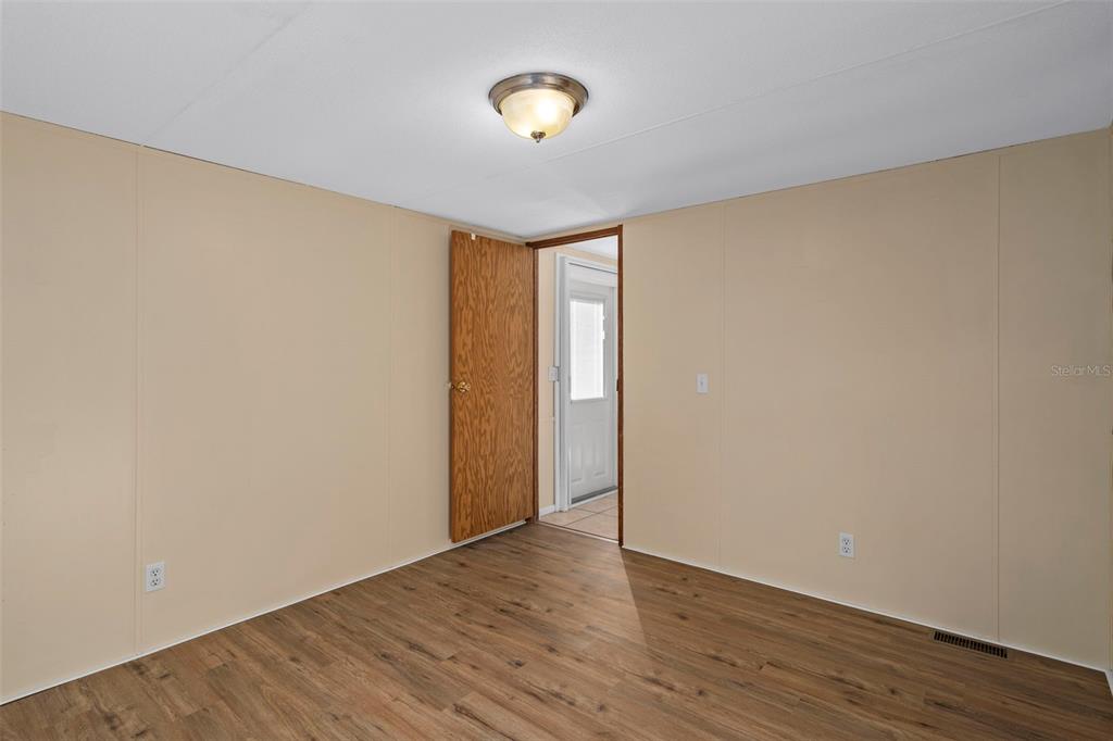 4939 West Foxhill Lane Homosassa, FL 34446 - Photo 19 of 37 a view of an empty room with wooden floor