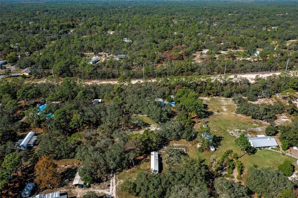 4939 West Foxhill Lane Homosassa, FL 34446 - Photo 33 of 37 an aerial view of residential houses with outdoor space and trees