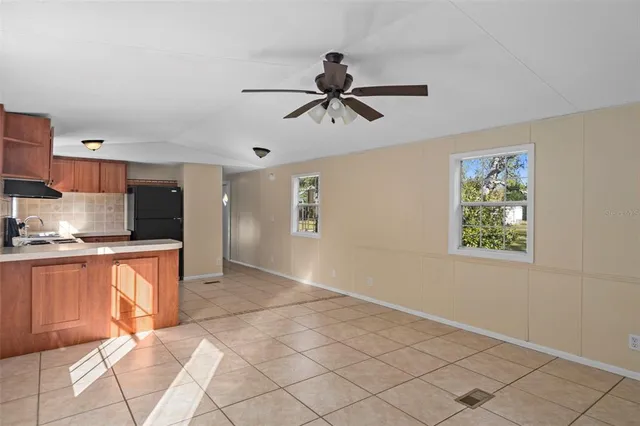 a view of kitchen with stainless steel appliances cabinets and window