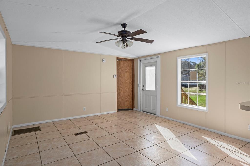 4939 West Foxhill Lane Homosassa, FL 34446 - Photo 8 of 37 a view of a livingroom with a chandelier fan and windows