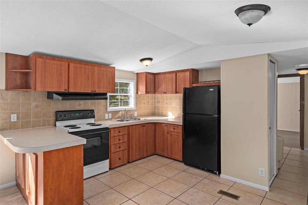 4939 West Foxhill Lane Homosassa, FL 34446 - Photo 9 of 37 a kitchen with stainless steel appliances granite countertop a refrigerator stove top oven and sink