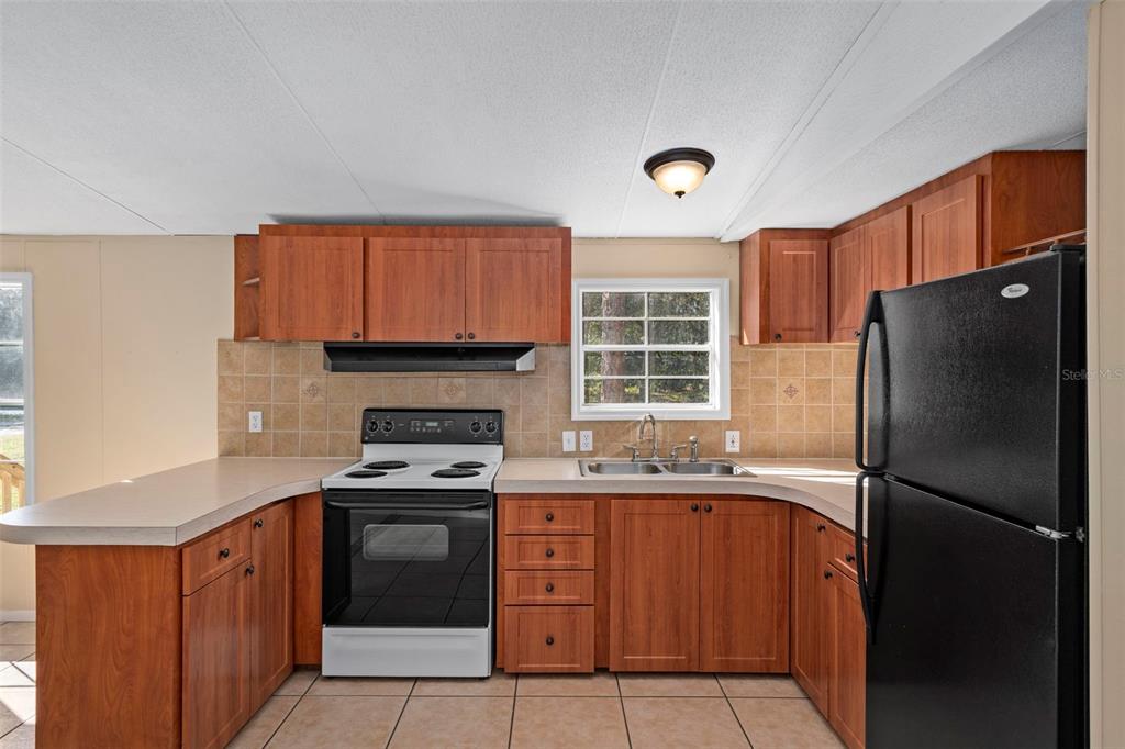 4939 West Foxhill Lane Homosassa, FL 34446 - Photo 10 of 37 a kitchen with a refrigerator sink and stove