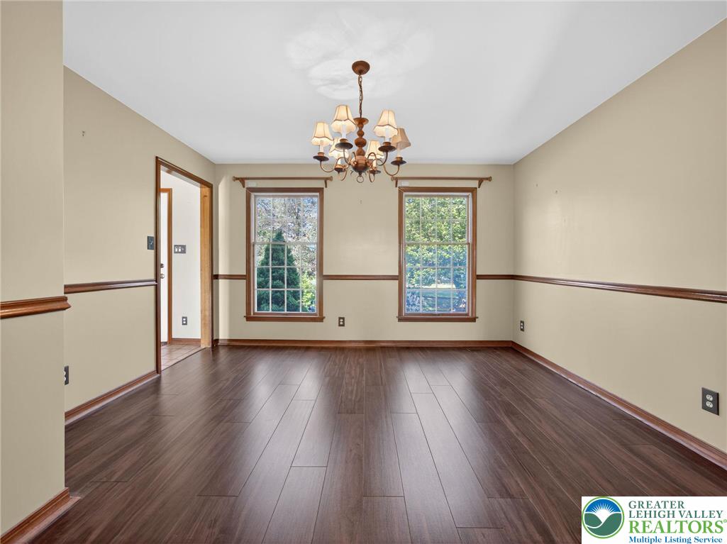 7098 Limerick Square Bath, PA 18014 - Photo 6 of 31 a view of an empty room with wooden floor and a window