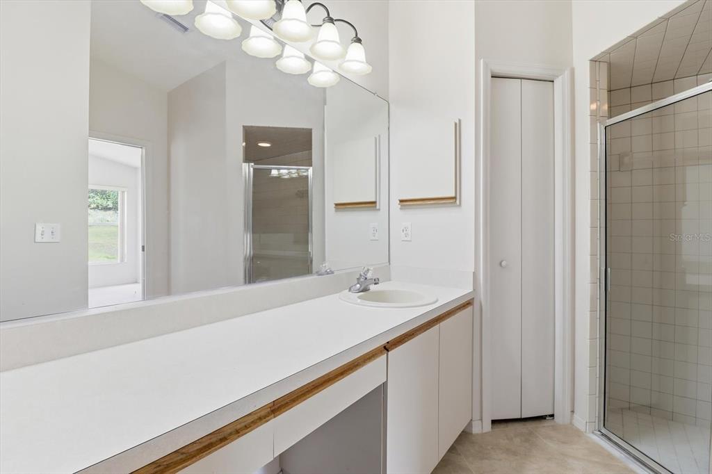826 West Cockatiel Loop Hernando, FL 34442 - Photo 23 of 40 a bathroom with a sink vanity and a mirror