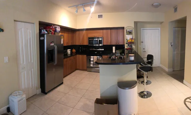 a kitchen with a refrigerator and a sink