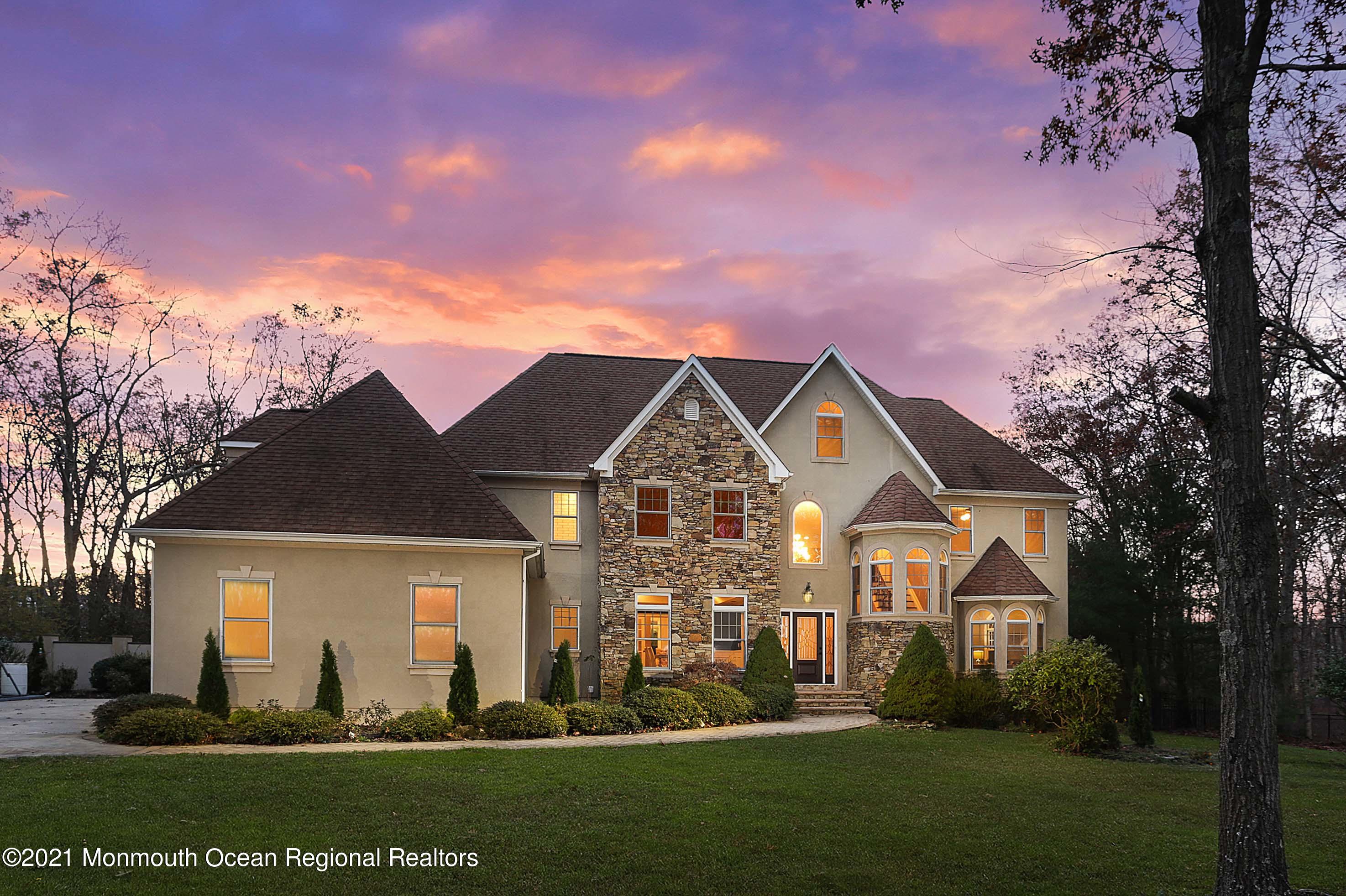 2104 Shadowbrook Drive Wall, NJ 07719 - Photo 4 of 84 a front view of a house with a garden and yard