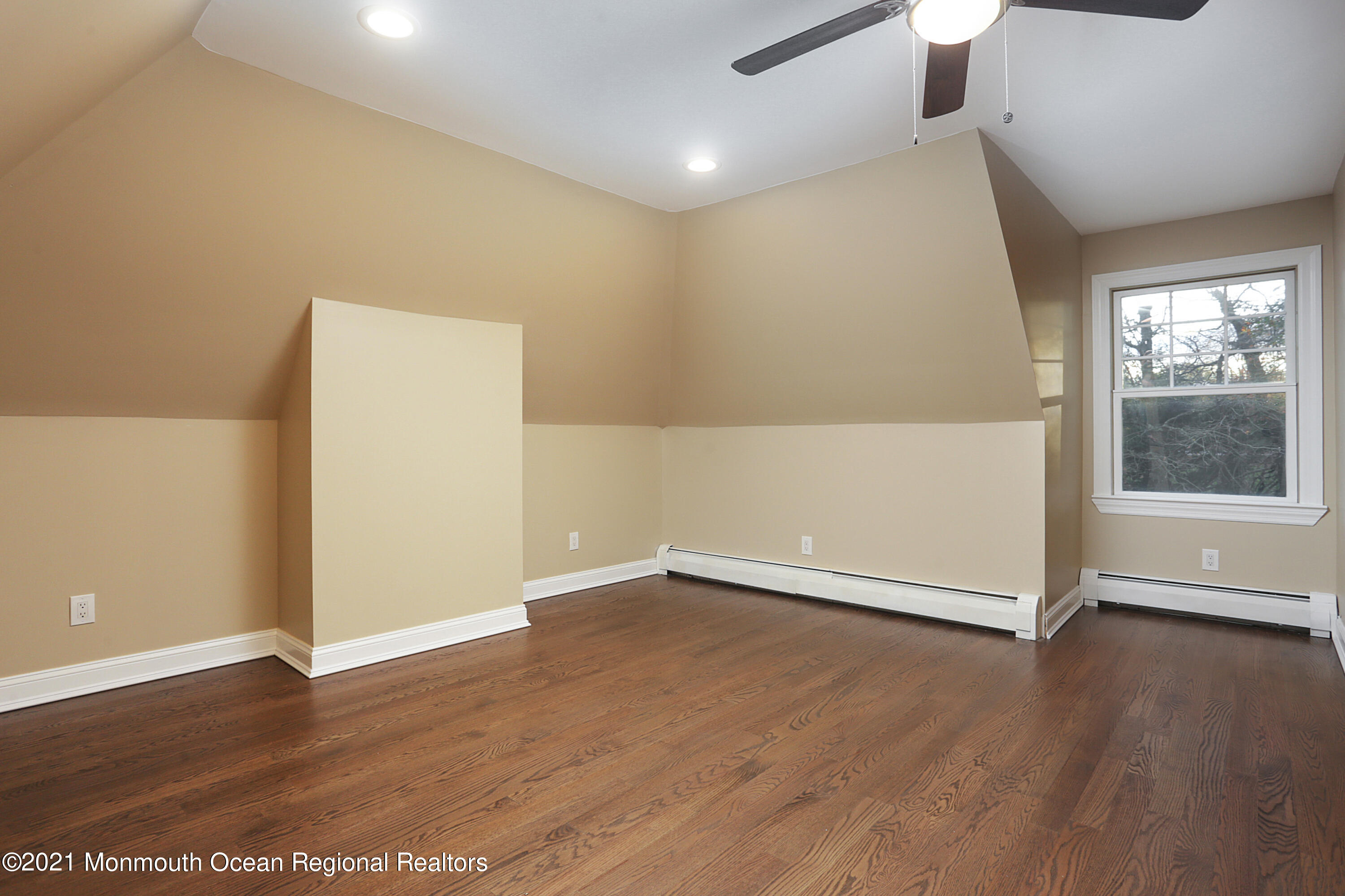 2104 Shadowbrook Drive Wall, NJ 07719 - Photo 38 of 84 an empty room with wooden floor and windows