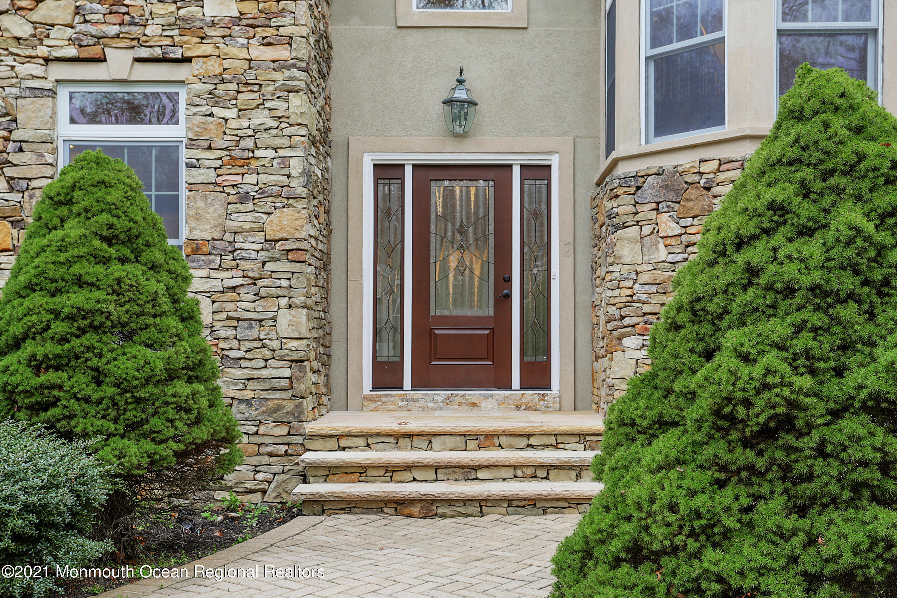 2104 Shadowbrook Drive Wall, NJ 07719 - Photo 5 of 84 a front view of a house with a garden