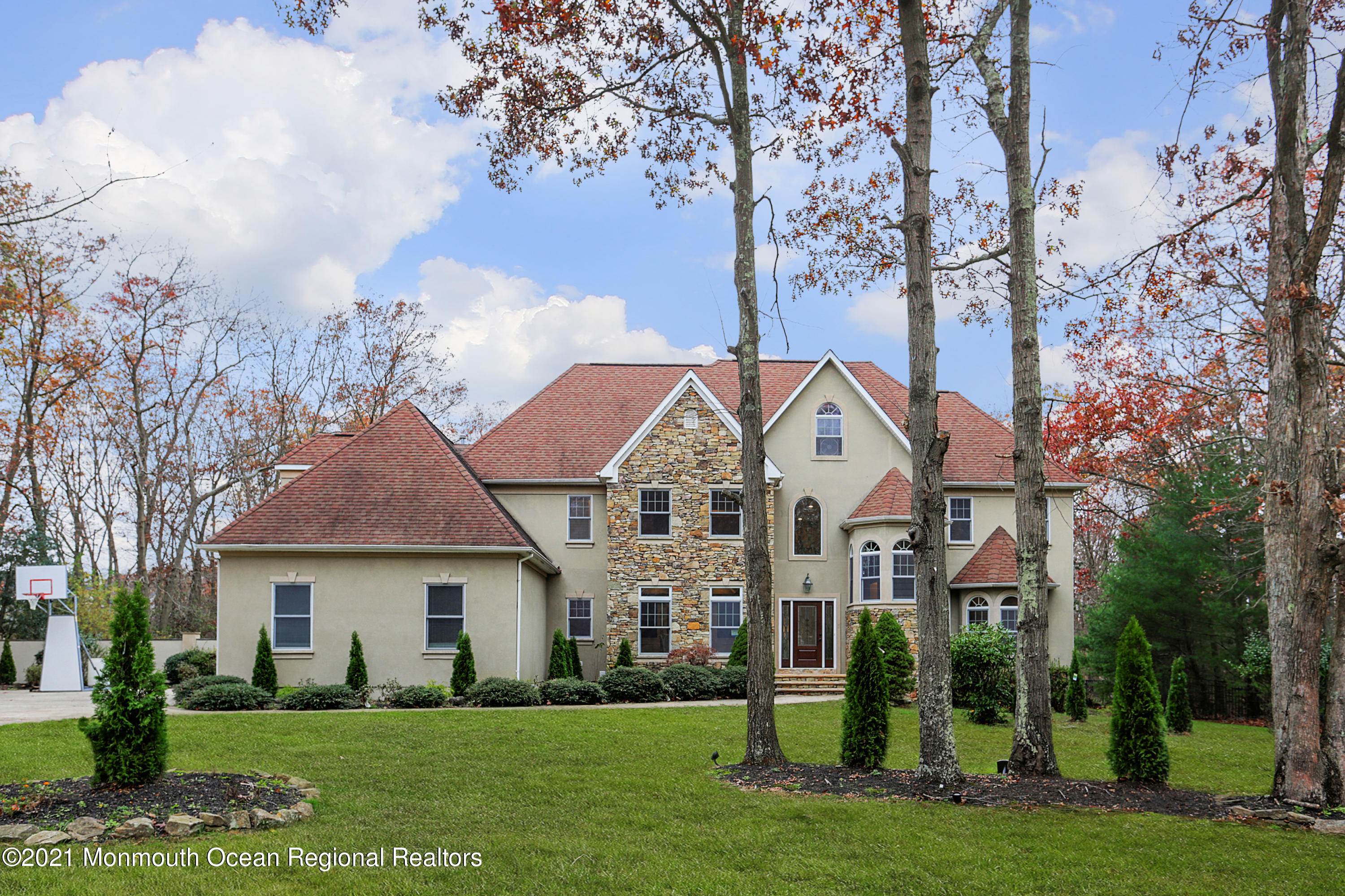 2104 Shadowbrook Drive Wall, NJ 07719 - Photo 49 of 84 a front view of a house with a garden and trees
