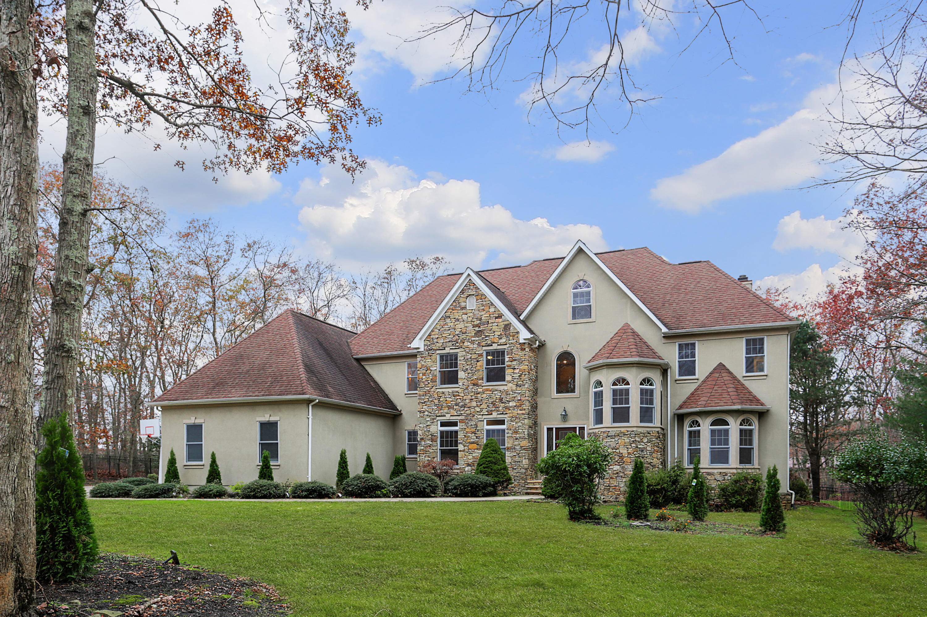 2104 Shadowbrook Drive Wall, NJ 07719 - Photo 50 of 84 a front view of a house with a garden