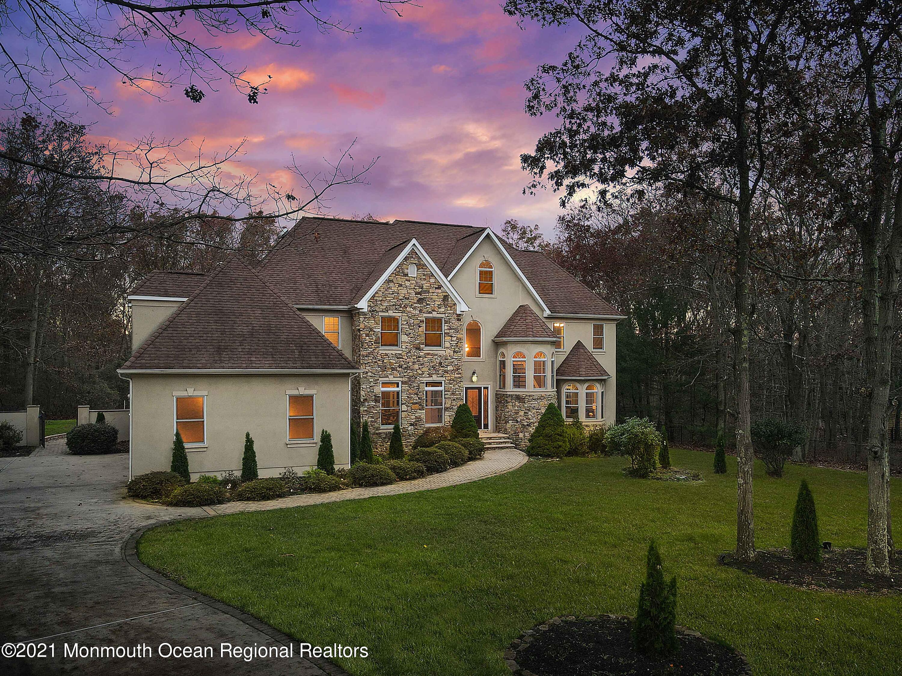 2104 Shadowbrook Drive Wall, NJ 07719 - Photo 84 of 84 a view of a white house with a big yard and large trees