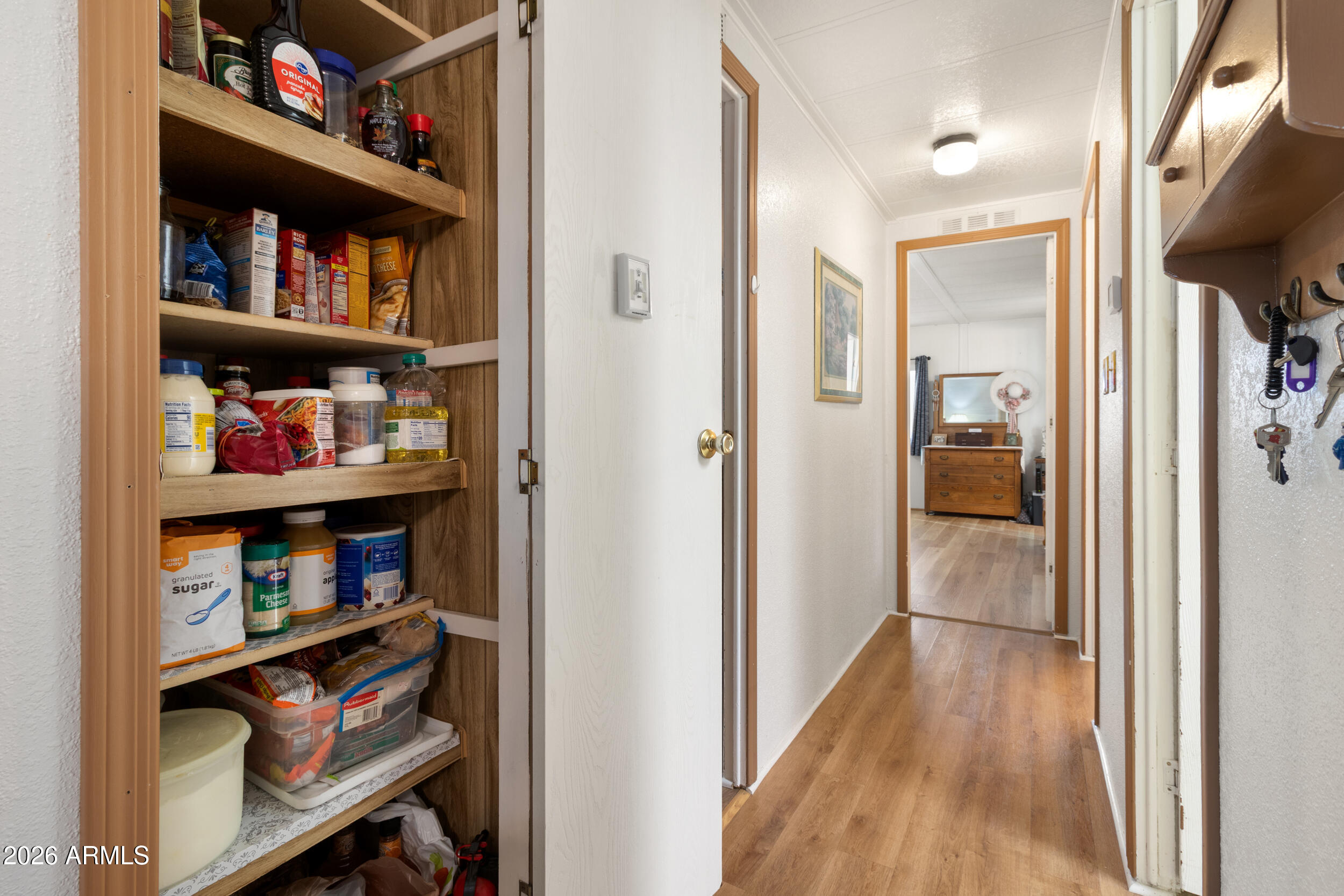 9302 East Broadway Road, Unit 178 Mesa, AZ 85208 - Photo 15 of 56 a view of a hallway with shelves