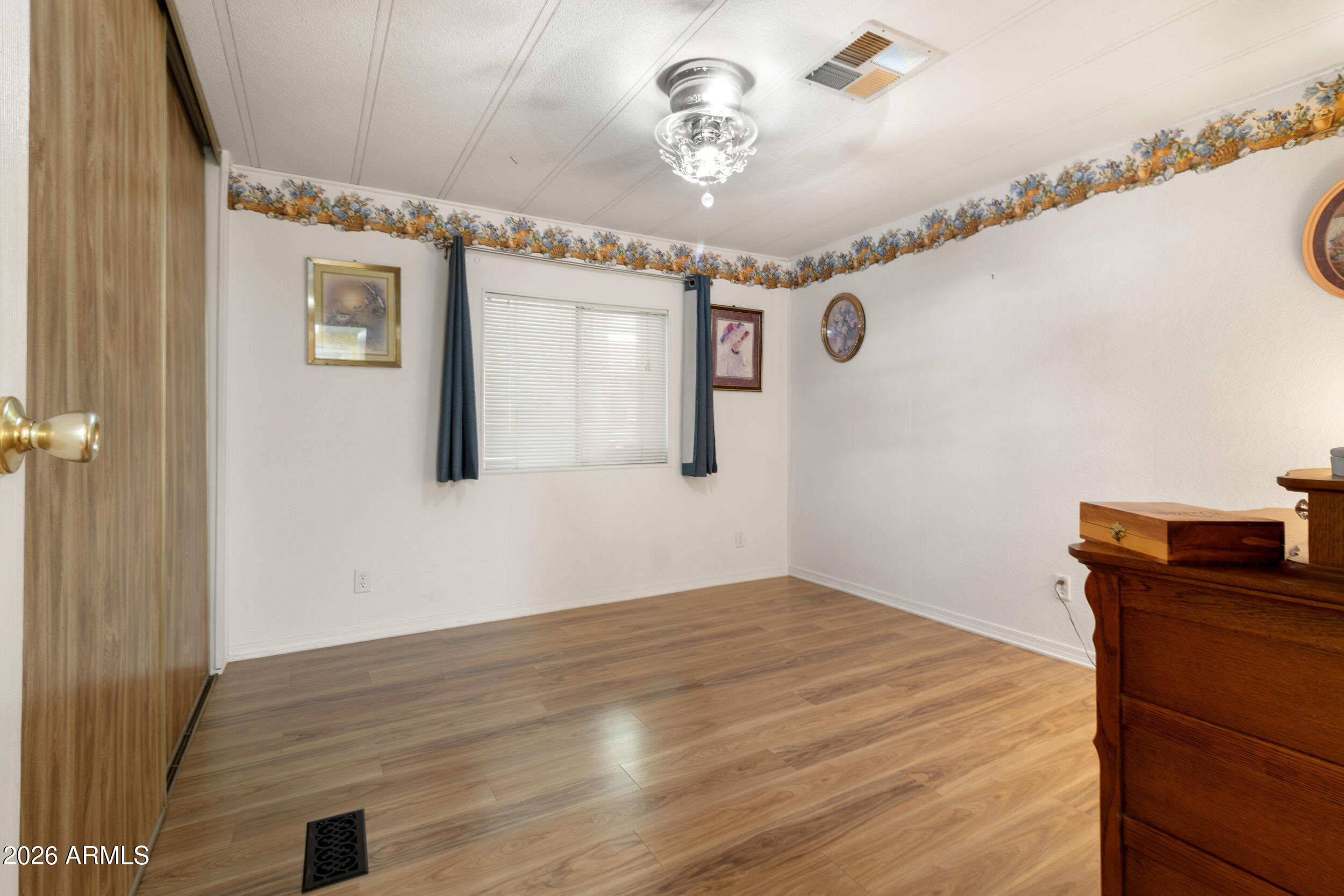 9302 East Broadway Road, Unit 178 Mesa, AZ 85208 - Photo 18 of 56 a view of a bedroom with a wooden floor