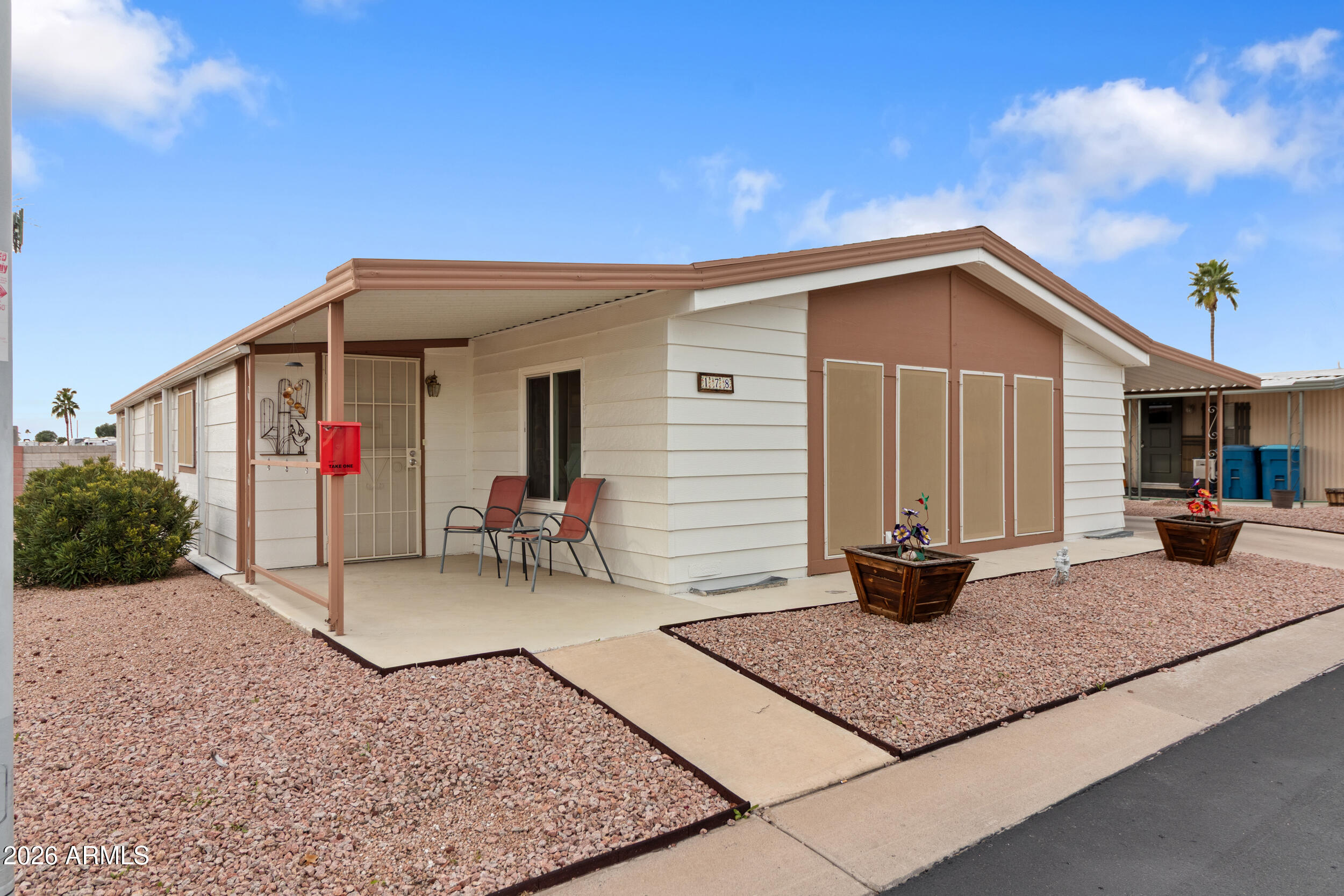9302 East Broadway Road, Unit 178 Mesa, AZ 85208 - Photo 2 of 56 a backyard of a house with seating space