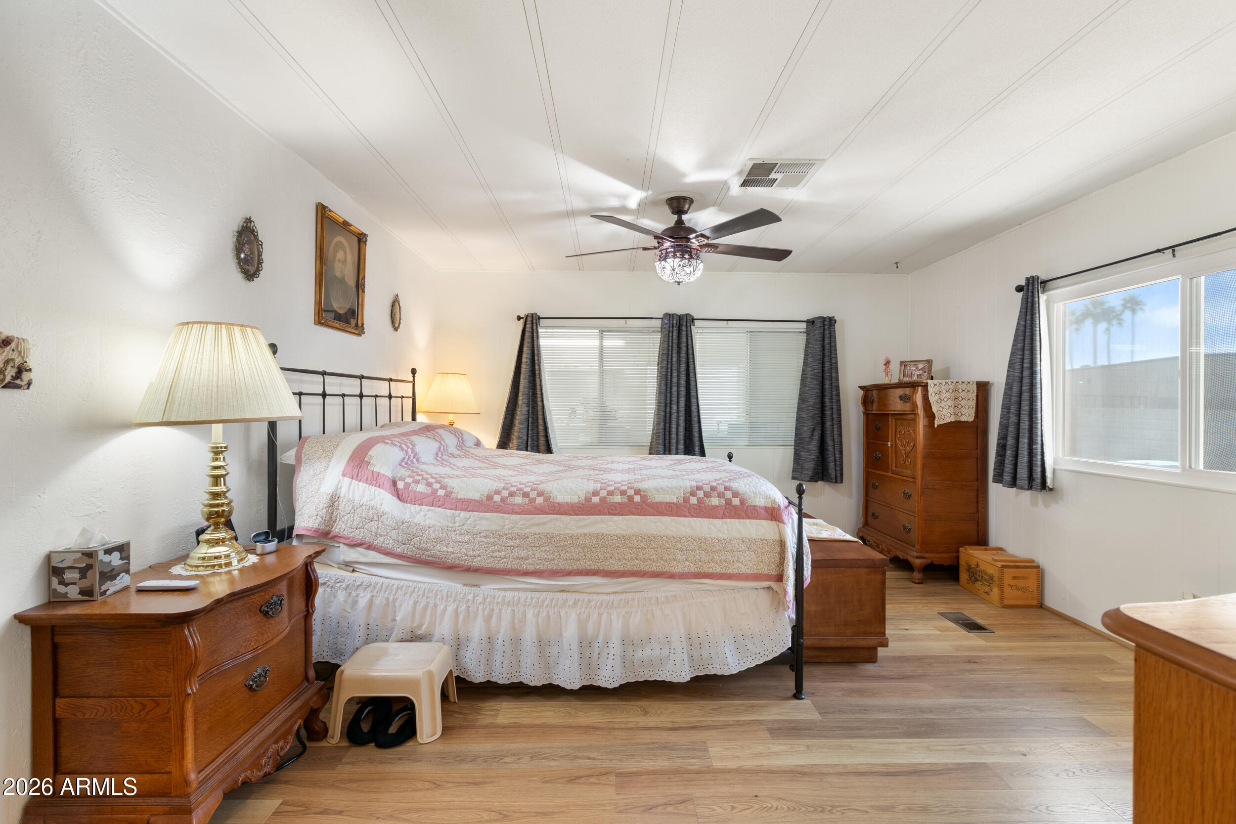 9302 East Broadway Road, Unit 178 Mesa, AZ 85208 - Photo 22 of 56 a bedroom with a bed and wooden floor