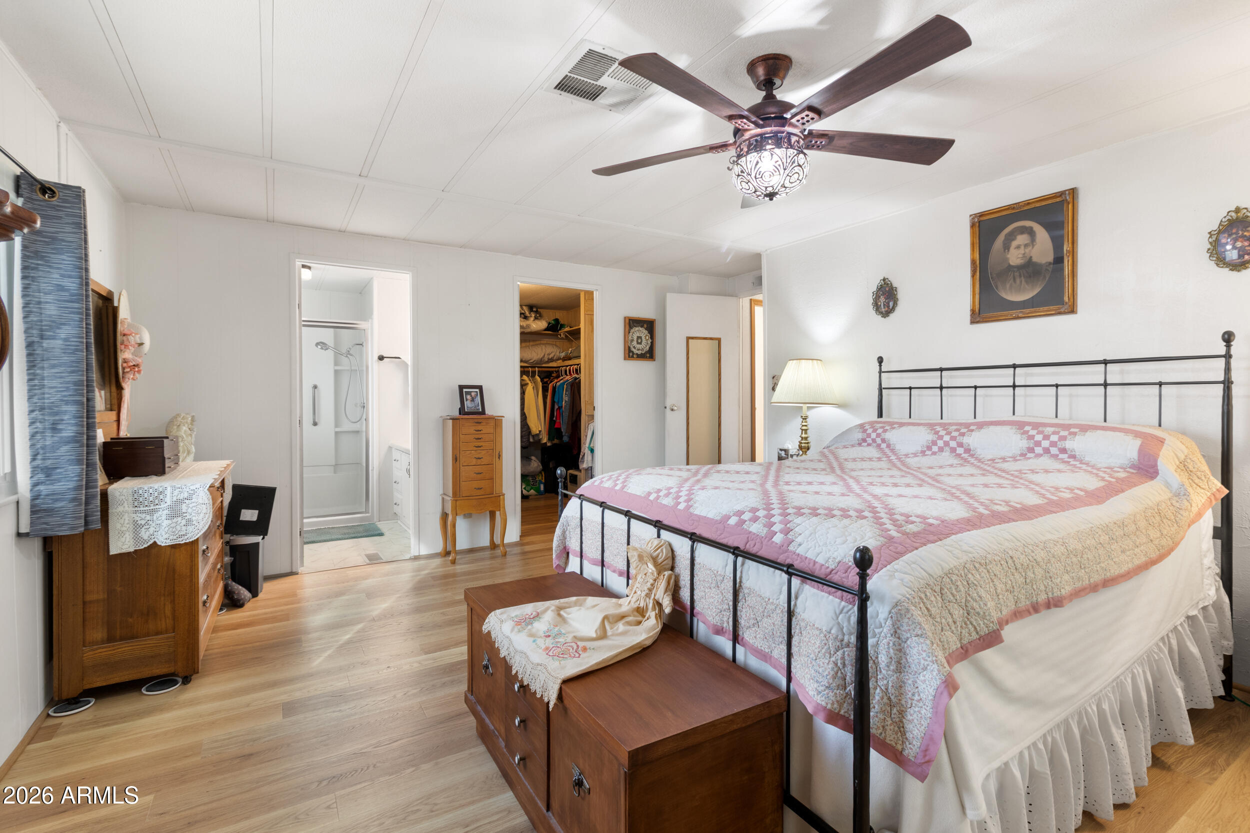 9302 East Broadway Road, Unit 178 Mesa, AZ 85208 - Photo 23 of 56 a bedroom with a bed and a chandelier